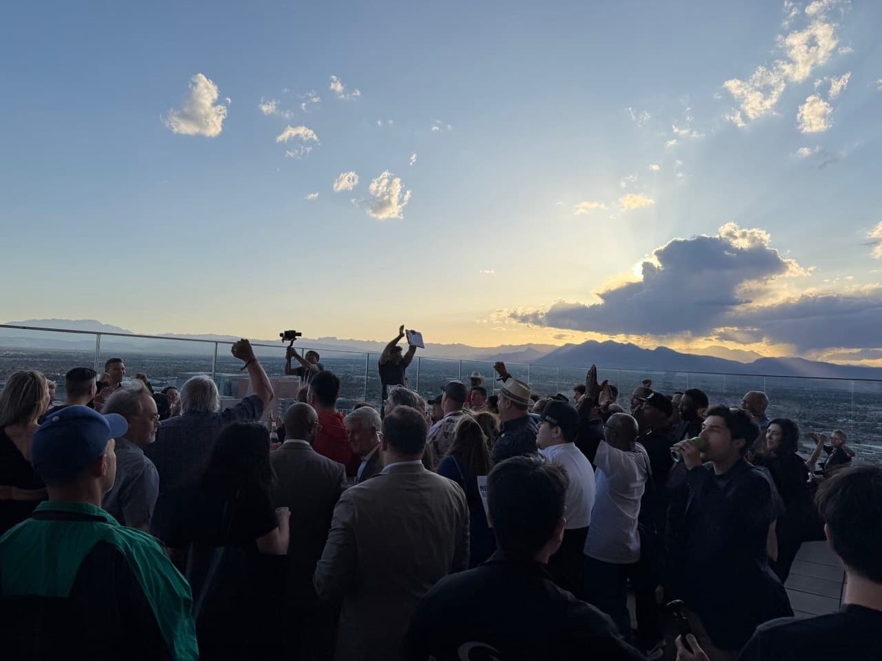 Crypto Mondays attendees on the rooftop at sunset