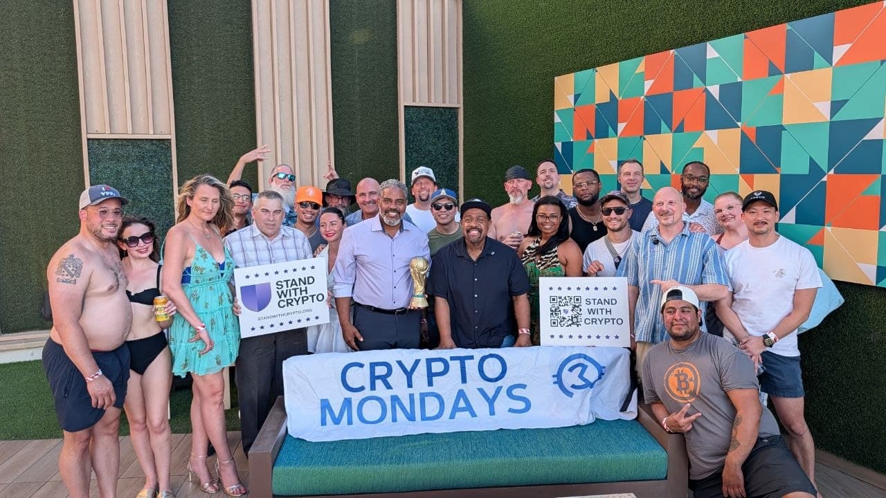 Crypto Mondays community posing together at a rooftop event